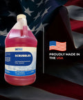 Heavy Duty Low Foam Auto Floor Cleaner, Straight Up Pro Grade Concentrate in one gallon jug with USA flag backdrop.