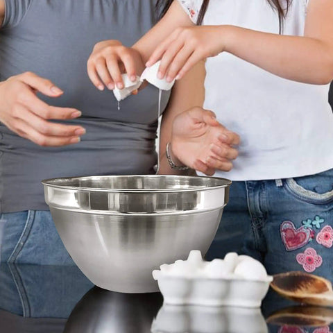 V Shaped Stainless Steel Mixing Bowl, 3 Quart Capacity, Deep Bowl Design on kitchen counter with eggs and people baking