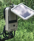 Sol Pak Solar Battery Pack For Trail Cameras 12V Rechargeable Li Ion 5000mAh Power Kit with insulated cable in outdoor setup.