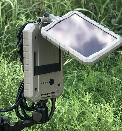 Sol Pak Solar Battery Pack For Trail Cameras 12V Rechargeable Li Ion 5000mAh Power Kit with insulated cable in outdoor setup.