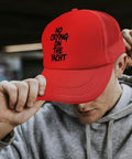 Man wearing red ponytail baseball hat for men lightweight hiking cap with anti sweat band breathable design ideal for outdoor adventure