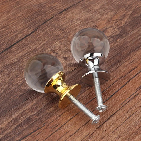 Crystal Glass Cabinet Knobs Set 4 Pack With Gold Finish Single Hole Drawer Pulls For Kitchen Cabinets And Furniture European Style Sparkling Crystal Door Handles Glam Up Your Cabinets With Sleek Gold Shine next to silver knob on wood background