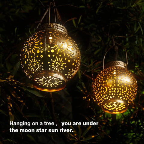 Outdoor Solar Lanterns 2 Pack Waterproof Hanging LED Lights With Metal Star Moon Sun Pattern illuminating a tree at night
