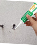 Person applying Two Set Wall Mending Repair Cream For Cracks Graffiti And Stains Easy To Apply Crack Paste to a wall hole.