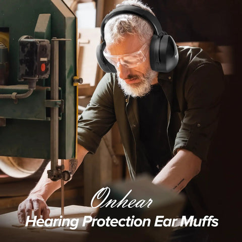 Man wearing Noise Canceling Ear Muffs For Adults And Kids, working in workshop with hearing protection gear.