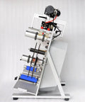 Top Notch Semi Automatic Round Bottle Labeling Machine With A Slick Label Applicator And 110V Wall Plug Power, side view showcasing label rollers and metal construction.
