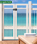 Heavy Duty Self Locking Gate Latch For Wood Fences And Garden Gates on a white slatted gate overlooking a beach.