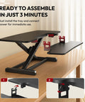Sanodesk 35 Inch Electric Height Adjustable Standing Desk Converter Riser showing assembly instructions on a wooden table.