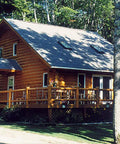 Premium Exterior Clear Top Coat For Stained Logs And Timber Siding Heavy Duty Semi Gloss Formula applied on a log cabin.