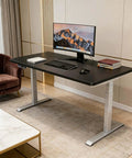 Top Shelf Electric Height Adjustable Computer Desk Featuring Memory Presets And Smooth One Touch Operation, black tabletop with monitor, keyboard, and chair.