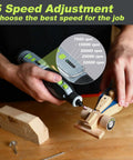 WORKPRO 12V cordless rotary tool with lime-green accents front close-up used on wooden toy car