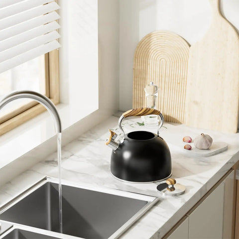 2.6 Quart Whistling Tea Kettle For Stovetop Black, Durable 304 Stainless Steel on a kitchen counter