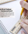 Hands using 12 Inch Wooden Ruler With Inch And Metric Measurements Dual Scale For School Office Or Home Use 30 Cm Handy Hardwood