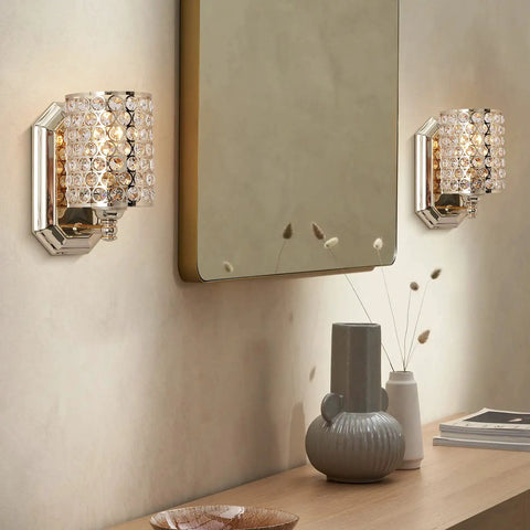 Elegant Two Pack Crystal Wall Sconce Lights With Champagne Finish Modern Minimalist Style Slick Polyhedral Crystal Shade in a living room.