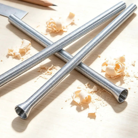 Four Piece Spring Coil Pipe Bender Set For Brass And Copper Tubing Features Quarter Inch And Five Sixteenths Size Tools With Flex Rollers, close-up view of metal tubing.