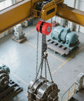 Front view of VEVOR hand chain hoist, 2-ton capacity, red block with steel chain hung from yellow overhead crane beam