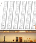 Stick On Wireless Under Cabinet Lights Anywhere With Remote Control Dimmable 20 LED Rechargeable Night Light For Wardrobe Kitchen Bedroom Hallway Stairs 6 Pack displayed with remote, USB cable, and installed under cabinets.