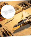 10 Piece Carbon Fiber Rod Set For Model Aircraft And Kites Lightweight And Easy To Install Round Rods For RC Aircraft Upgrades And Wing Spars Perfect For Replacing Worn Or Damaged Parts And Strengthening Structures on a workbench with tools and model jet