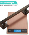 Rustic 12 Inch Heavy Duty Barn Door Handle Pull For Sliding Doors Solid Metal Construction With Oil Rubbed Bronze Finish Large Design For DIY Barn Doors Gates Sheds And Garages All Weather Ready shown on a scale weighing 893g.