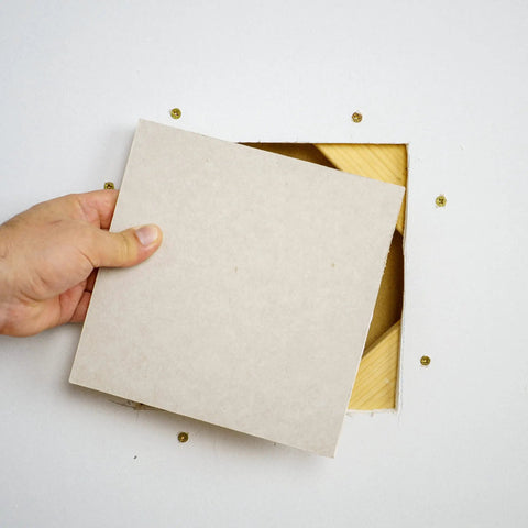 Inserting panel from Pro Grade Drywall Repair Kit For Home And Office Fix Holes Fast With 12x12 Inch Panels Includes Backing Boards Joint Compound Patch Sanding Pad And All Essential Tools For A Clean Seamless Finish into wall hole