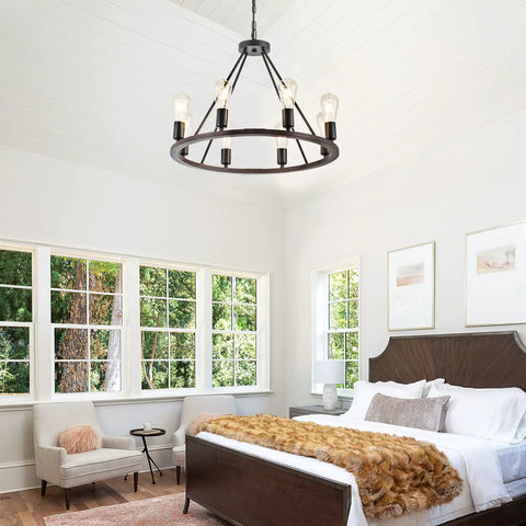 Black Wagon Wheel Light With Eight Lights Rustic Farmhouse Style Ceiling Pendant in bedroom setting.