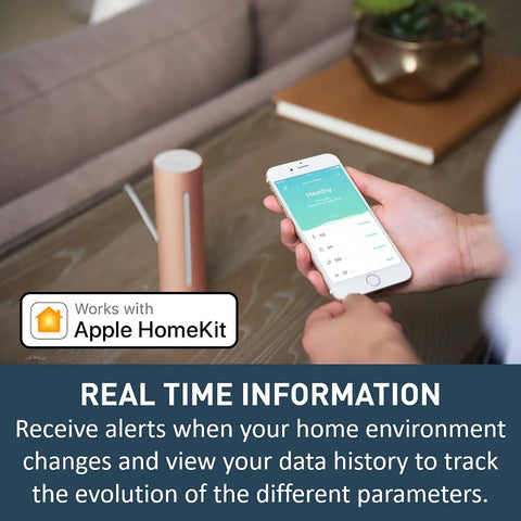 Person using smartphone app showing real-time data from Indoor Air Quality Monitor With CO2 Sensor, Temperature, Humidity And Noise Levels, Real Time Alerts, Dope Smart Home Sensor For Healthier Living, App Profiles For Baby Asthma And General Use on table.