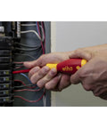 Using Insulated SoftFinish Cushion Grip Screwdriver Tray Set on electrical panel, focus on safe for live circuits handle.