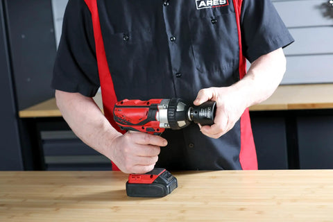 Person using Dodge Axle Nut Socket One And Eleven Sixteenths Inch One Half Inch Drive Chrome Moly with power drill