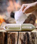 Rinse Free Dish Wipes For Camp Kitchens That Are Biodegradable And Pre Moistened With Food Safe Formula package on a log.