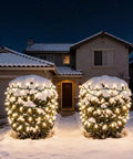 200 LED Warm White Christmas Lights on 66ft green wire illuminating snow-covered shrubs in front yard