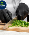 Person chopping herbs wearing Built Tough Black Nitrile Exam Gloves 5.1 Mil Heavy Duty Powder Free Disposable.
