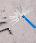 Top Shelf Feeler Gauge Set With Rock Solid Stainless Steel Blades for accurate gap measurements on a work surface with screws.