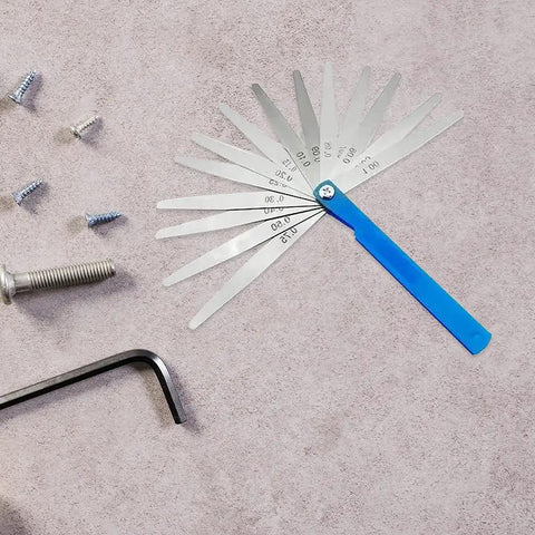 Top Shelf Feeler Gauge Set With Rock Solid Stainless Steel Blades for accurate gap measurements on a work surface with screws.