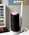 Heavy Duty Thread Spool Stand For Sewing Machines Featuring A Sick Anti Tangle Guide And Jumbo Cone Holder in white with black thread
