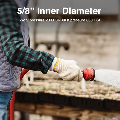 Side view of red rubber garden hose with a spray nozzle used outdoors by a gloved hand.