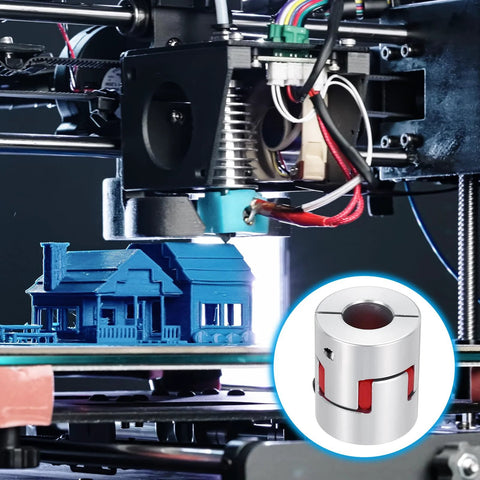 Aluminum shaft coupling for 8–14 mm shafts with red jaws; silver connector shown near blue 3D-printed house on printer bed