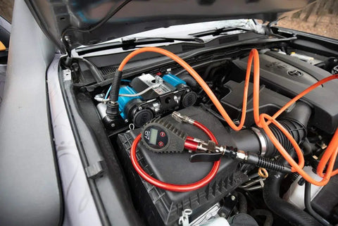 CKMTA12 12V On Board Twin High Flow Air Compressor installed in vehicle engine bay for air lockers and tire inflation