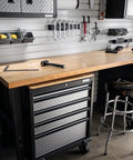 Heavy Duty Chrome Garage Work Stool With Double Ring Leg Construction, 300 Lb Capacity, next to workshop toolbench
