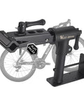 Heavy Duty Bike Repair Stand with Adjustable Clamp, shown wall mounted with bike in background, holds up to 88 lbs