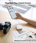 Person using CreateMate Mini SD Card Reader Case With 6-Slot Storage And Ultra Fast 2-In-1 USB 3.1 Type-C Transfer For SD And Micro SD Cards connected to phone with camera in view.