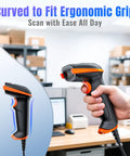 Pro USB 1D 2D QR Barcode Scanner With IP65 Dustproof Shockproof Waterproof Built Tough, ergonomic curved handle, being held in an office.