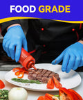 Chef wearing Latex Free Vinyl Exam Gloves 4 Mil Disposable Small Blue Box Of 100 Powder Free For Medical Dental Lab Use with Tough As Nails Feel and Superior Tactile Feedback, garnishing steak with sauce in kitchen.