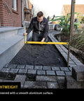 48 Inch Heavy Duty Aluminum Spirit Level Featuring Dead On Accuracy being used for smooth layout work in construction.