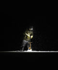 Person using Double Power Rechargeable CREE LED Headlamp With 1800 Lumens in dark snowy environment, highlighting rugged use.