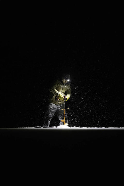 Person using Double Power Rechargeable CREE LED Headlamp With 1800 Lumens in dark snowy environment, highlighting rugged use.