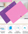 Front view of pink and purple double-sided A3 cutting mats; self-healing with metric and inch grid.