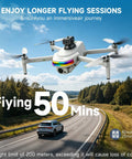 GPS Drone With 4K Camera And 5.5 Inch Touchscreen Remote flying over a scenic road, demonstrating 50-minute flight capability.