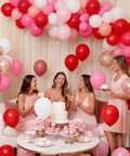 66 Piece 12 Inch Hot Pink And Red Balloons Set With White And Gold Confetti For Valentines Day Engagement Wedding Bachelorette Birthday Party Decor Durable Matte Latex in a festive party setting with women in pink dresses.