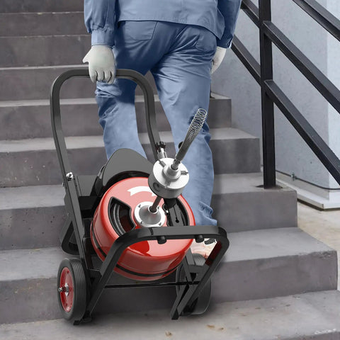 Person carrying Rugged Auto Feed Drain Auger 75 Ft 3/8 Inch Steel Core Cable Electric Sewer Snake up the stairs.