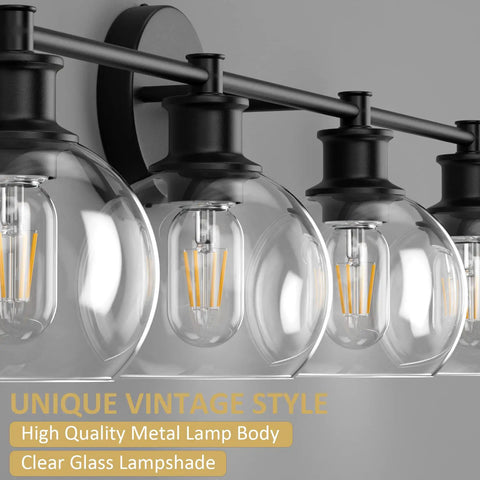 Four Light Matte Black Industrial Vanity Light Fixture Over Mirror With Clear Glass Globes close-up, showcasing bulb and shade.